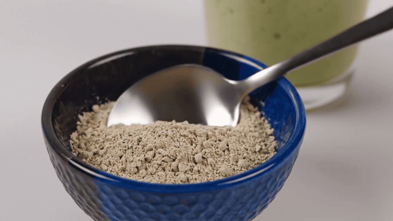 Close-up of golden sea moss powder in a spoon
